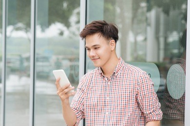 handsome young asian man look at cellphone