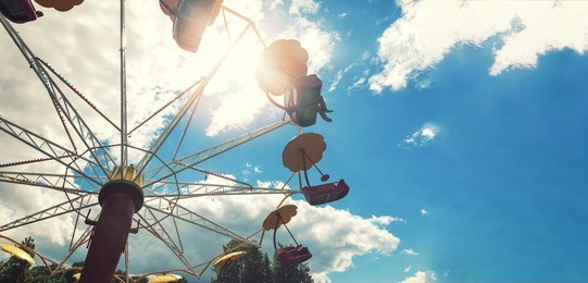 amusement park carousel against blue sky with copy space