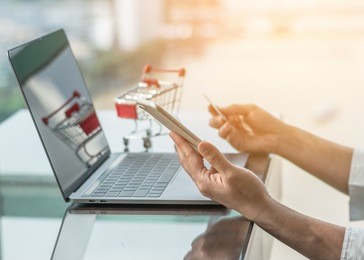 online shopping and e-commerce digital marketing concept via computer website, mobile smartphone app and internet wireless communication technology in people or shopper modern city lifestyle 