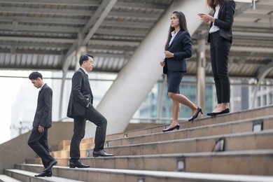 blurry of moment businessman running fast upstairs. horizontal outdoors shot.walking up stairs in city to success.