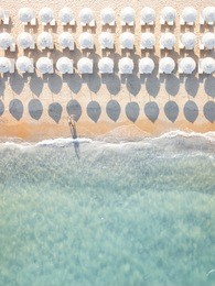 aerial view of amazing beach with white umbrellas and turquoise sea at sunset. mediterranean sea, sardinia, italy.