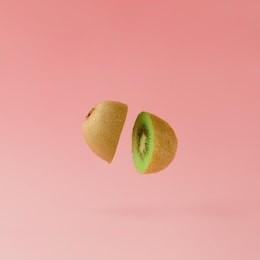 kiwi sliced on pastel pink background. minimal fruit concept.