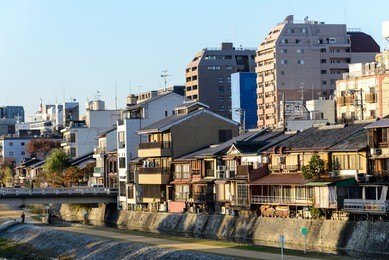 old town of kyoto city with house and resident zone along kamo river / kamogawa river at sun rise, gion, kyoto, japan