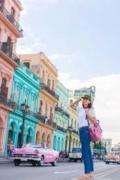 tourist girl in popular area in havana, cuba. young woman traveler smiling