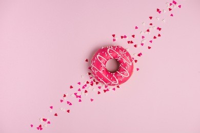 donuts with icing on pastel pink background with copyspace. sweet donuts.