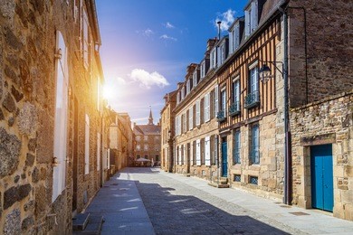 narrow street with old traditional houses in histoical part of dinan, brittany (bretagne), france