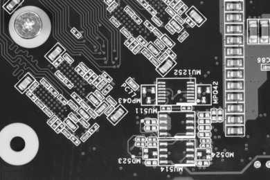 circuit board full of small capacitors. electronics industry. black and white retro style.