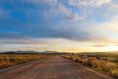 gravel road in the countryside at sunset                               