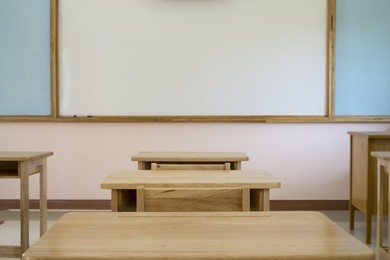 desk in classroom with whiteboard