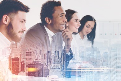 side view of members of a business team sitting together at a table and looking at a person off camera and listening to them. cityscape. mock up toned image double exposure