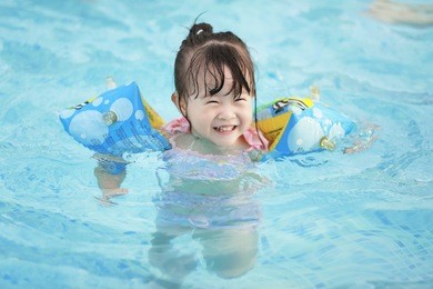 asian little girl in swimming pool