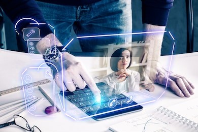 man with pad leaning on desk at workplace and communicating with young woman via abstract futuristic screen hologram. concept of network, communication, family, technology, augmented reality 
