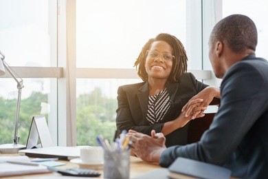 beautiful smiling african-american business lady chatting with coworker