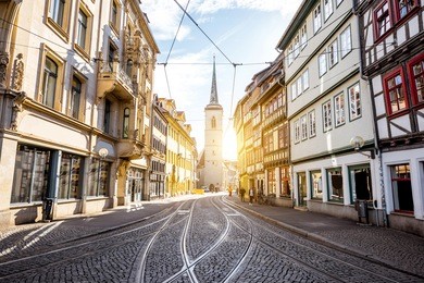 street view with church tower at the old town of erfurt city in germany