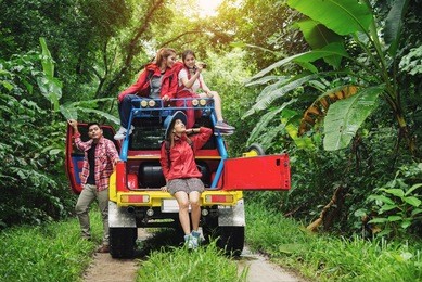 group of people hiking and traveling for camping in the forest with road trip in weekend summer - travel and recreation concept