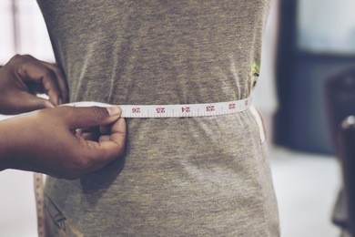 close-up of tailor woman taking measures shirt using tape meter.in selective focus,cross processing and split tone instragram like process.