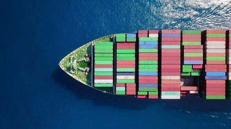 mega container ship at sea - top down aerial view