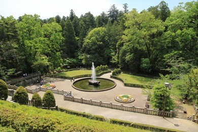 female tourist walking around a fountain in naritasan temple, narita, japan,