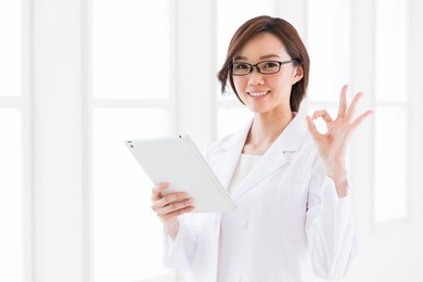 young attractive asian woman in a white coat