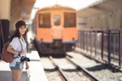 traveler woman walking and waits train on railway platform.vintage color