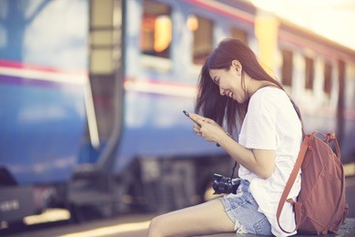 traveler woman walking and waits train on railway platform.vintage color