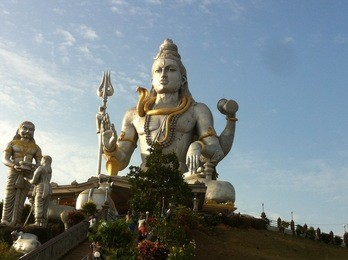 a huge statue of lord shiva made on a island in india.