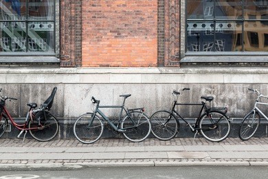 retro bicycle in front of the brick wall. bicycle at the city. bicycle against brick wall in a street. retro bicycle on roadside with vintage brick wall building background. bike on the an old street.
