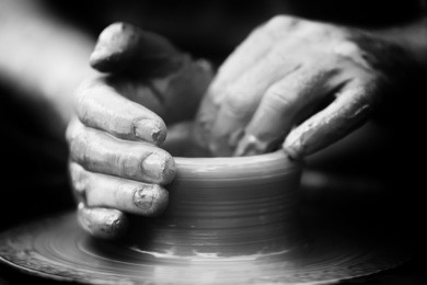 hands of a potter. potter making ceramic pot on the pottery wheel