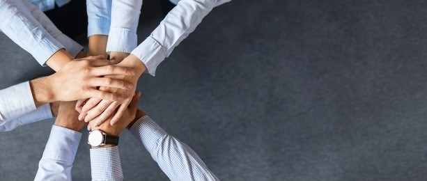 close up top view of young business people putting their hands together. stack of hands. unity and teamwork concept.
