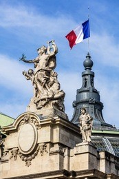 french flag waving on top of the great palace (grand palais des champs-elysees) in paris, france