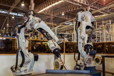 industrial robots are welding test run program in car factory
