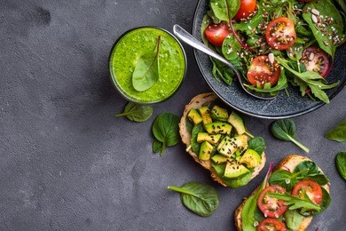 vegan/vegetarian dinner background. vegetable salad, sandwiches, fresh green smoothie. healthy eating concept. detox diet/plan. space for text. top view. vegetarian lunch. weight loss. cleanse program