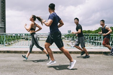asian young people running on the bridge together