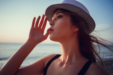 asian woman wearing fashion straw beach hat for skin care sun protection. face skincare beauty concept. beautiful chinese caucasian mixed race young adult girl portrait on summer vacation travel.