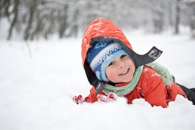 little boy having fun in the snow