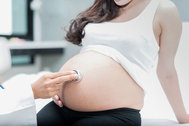 close up of doctorÃ¢â?¬â?¢s hand checking of pregnanting woman