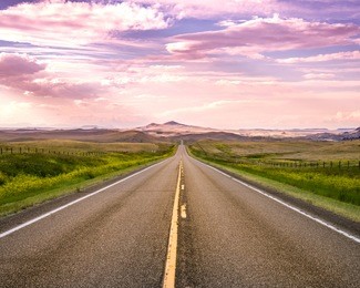 road to mountain under clouds