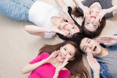 young people smile happily and lying on floor