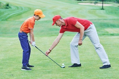 boy playing golf in summer