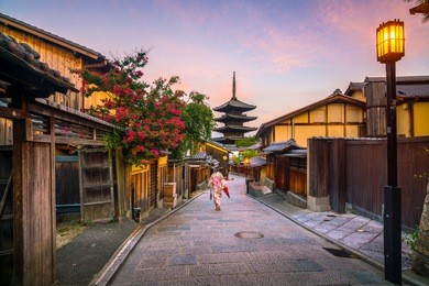 japanese girl in yukata with red umbrella in old town  kyoto, japan