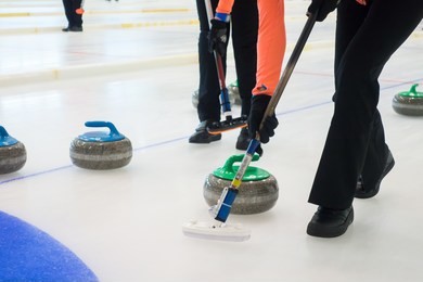 team members play in curling at championship