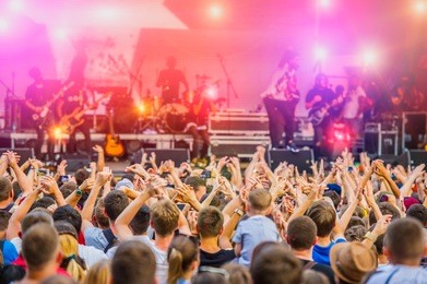 musical concert rock band in the evening outdoors and fans