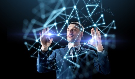 business, people, augmented reality and network concept - businessman working with virtual low poly projection over black background