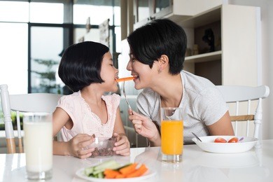 happy asian family enjoying a healthy snack at home.