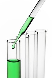 pipette with emerging drop of liquid over test tubes