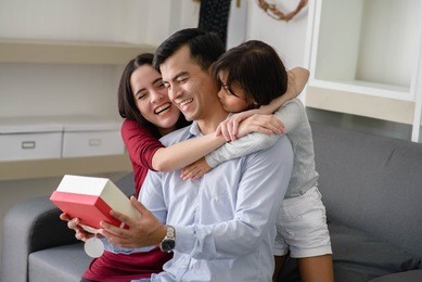 father's day.happy family ,activity of family at home .daughter have a gift for daddy.