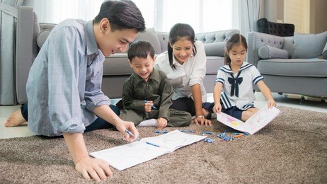father and mother teaching children to do their homework at home ,and relax with they son to do home work by draw and paint, family , kid , education concept.
