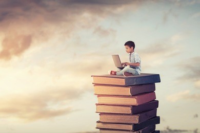 school child using laptop on the books.study and education concept.