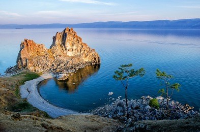 summer sunset over rock of shamanka burhan on olkhon island in lake baikal, russia