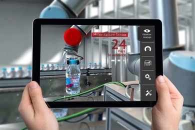 engineer hand using tablet, automation robot arm machine in smart factory with tablet real time vibration analysis monitoring system application for check motor failure. industry 4th sensor concept.